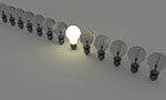 Several light bulb in a line, one in the middle is on, the others are off.